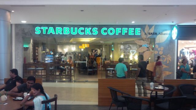 On the outside, just like any other Starbucks in any other mall.  Excepting the "Tata" sign in top right, which is pretty much the parent company of any venture in India.