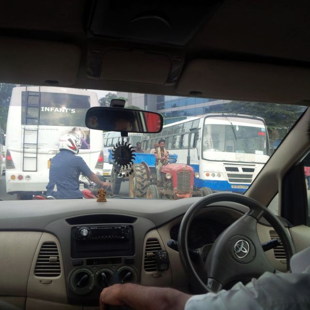 Bangalore has traffic.  In specific, Bangalore has our mini van, a motorcycle, two busses, and a tractor.