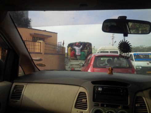 Check out the truck with a whole gang of guys hanging onto the back.