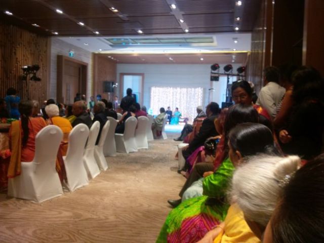 Reception hall, with the stars of the show on stage.