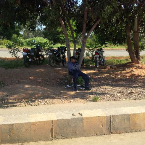 Why not? (well, if he's actually on the clock as the toll gate guard to the airport road, then there's lots of reason why not, but maybe he's on break?)